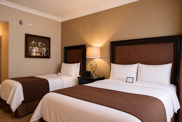 A twin and a queen-sized bed in the Deluxe Queen Twin room.