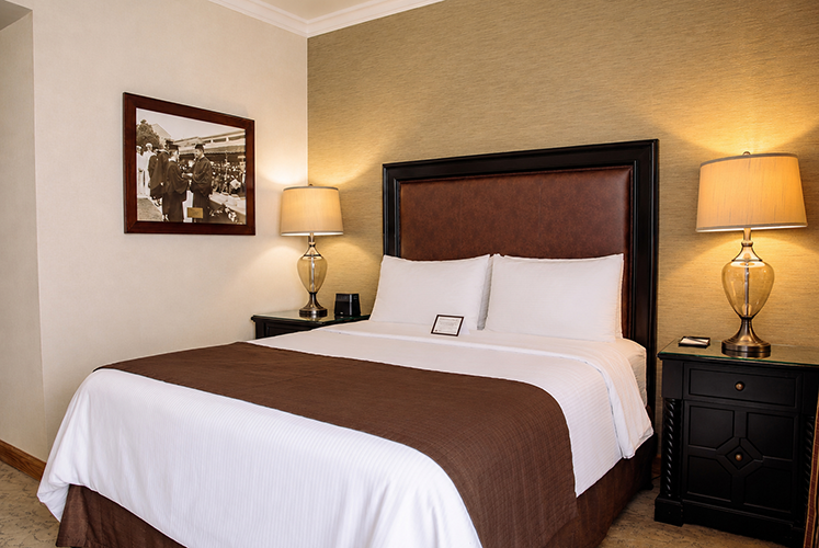 A queen-sized bed in a Deluxe Queen Room.